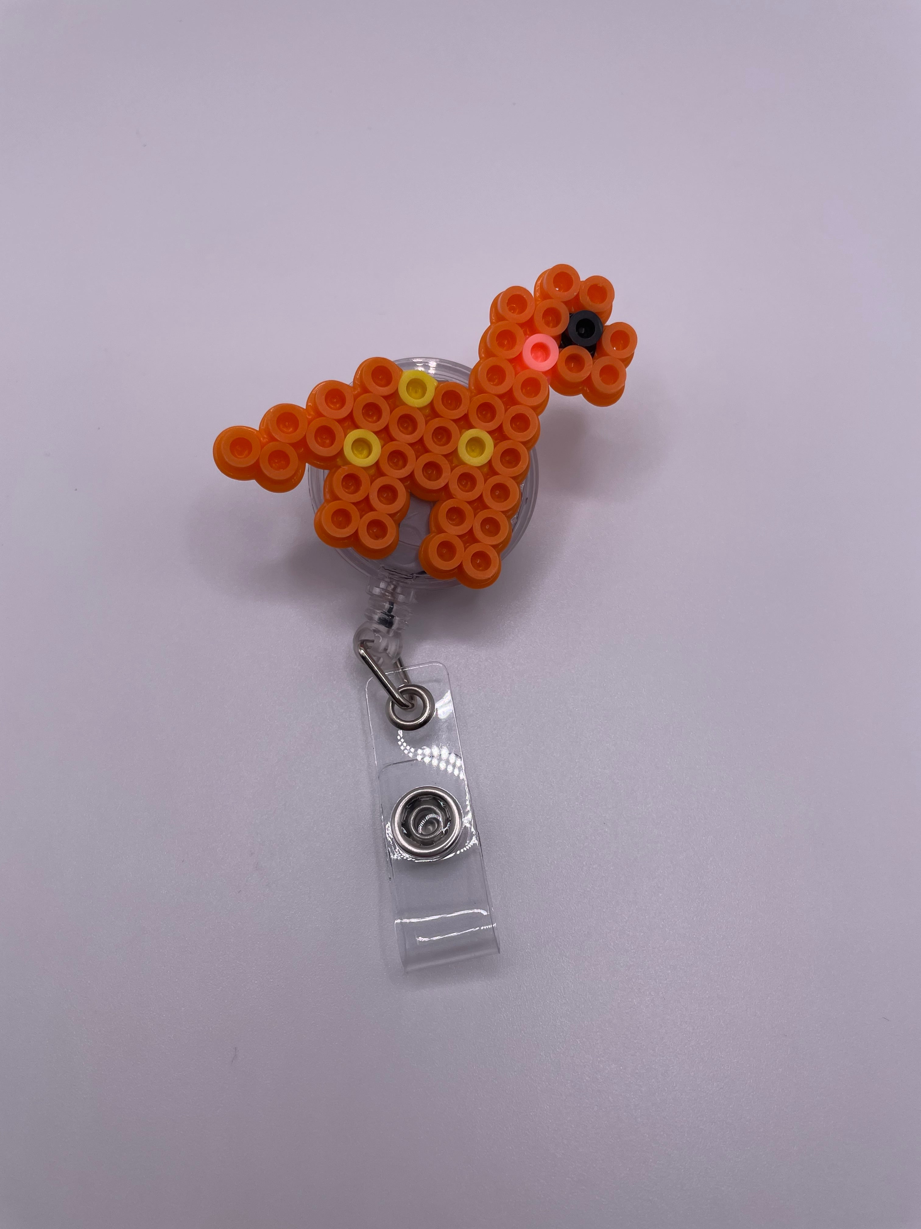 Orange Dino Badge Reel